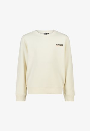 Sweat-shirt couleur crème à manches longues, col rond et poignets côtelés. "NEW YORK" imprimé en brun foncé sur le côté gauche de la poitrine.