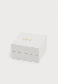 White textured gift box with a gold "LIUJO" logo on the lid, designed with a simple square shape and clean lines. Closed, two-level structure.