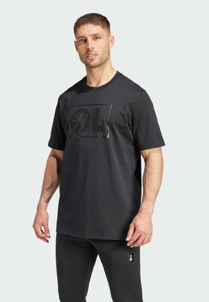 Black cotton t-shirt with a round neckline, short sleeves, and a raised logo design at the front. Straight-cut hem.