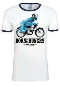 White t-shirt with blue accents, featuring a graphic of a blue furry character on a motorcycle, and text “BORN TO BE HUNGRY EST. 1966.”