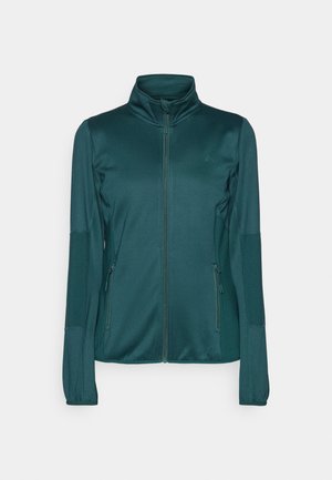 Veste zippée teal en tissu lisse, avec des manches longues, un col montant et deux poches frontales zippées. Accents texturés sur les manches.