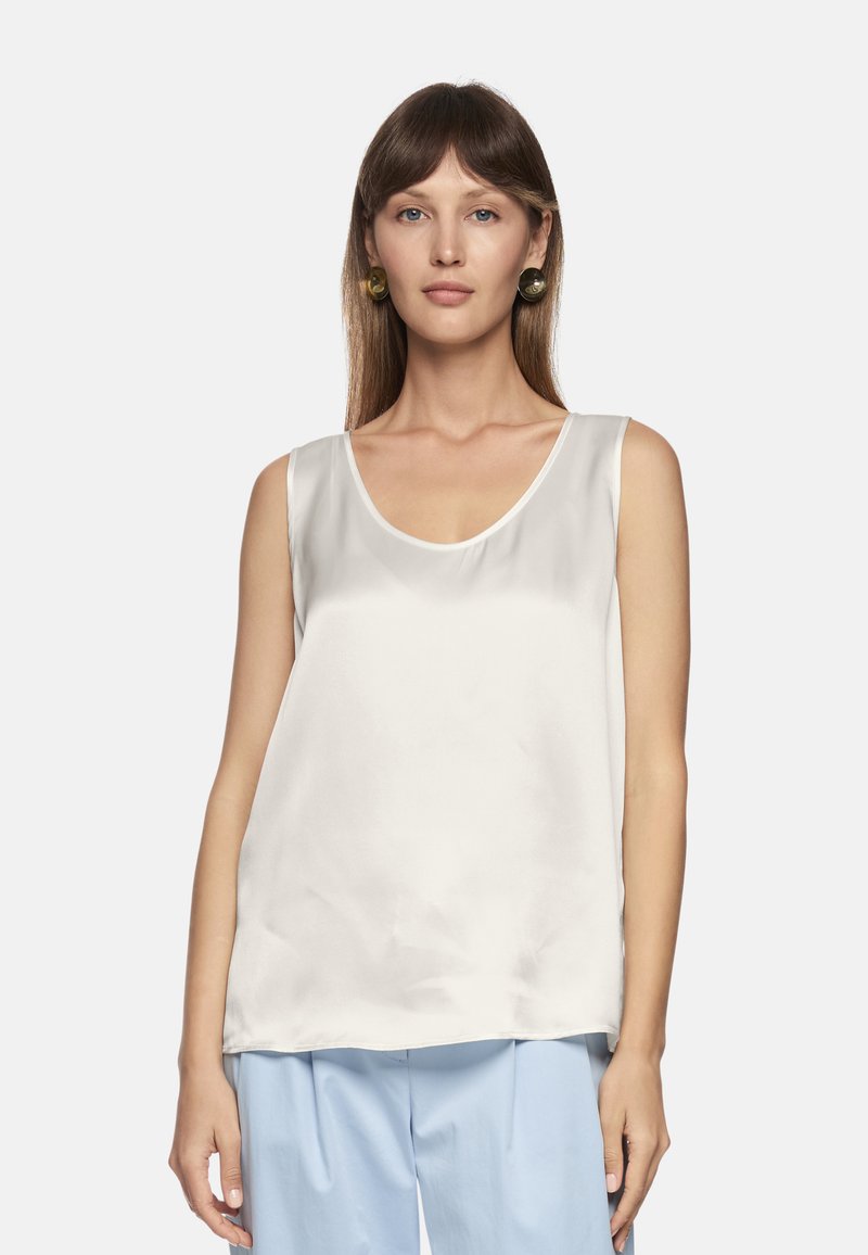 Satin sleeveless top in off-white with a scooped neckline and loose fit, featuring a smooth texture and subtle sheen.