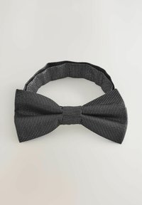 Black bow tie with a textured fabric featuring white diagonal stripes, secured with a central pleat, designed with an adjustable strap.