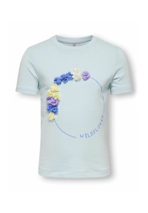 Light blue short-sleeve shirt with a circular arrangement of 3D blue, yellow, white, and purple fabric flowers and the word "WILDFLOWER."