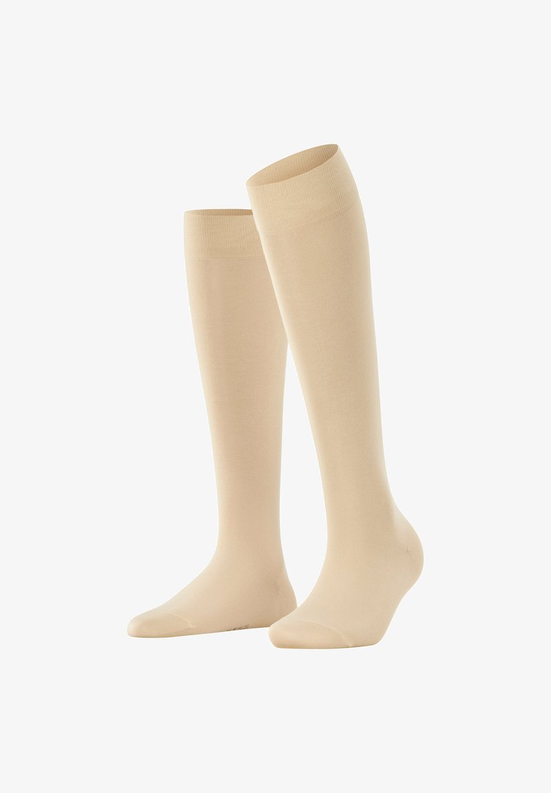 Beige kniehohe Socken aus einem glatten, dehnbaren Material mit einem gerippten Bündchen. Mit verstärkter Zehenpartie und nahtlosem Design.