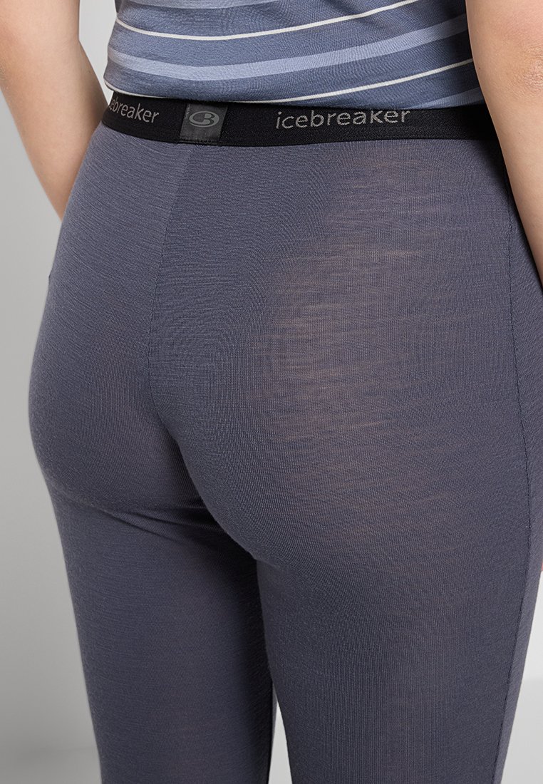 Grau Leggings aus leichtem Stoff, mit einem schwarzen elastischen Bund mit "icebreaker"-Branding. Glatte Textur mit taillierter Passform.