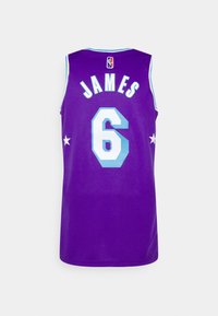 Maillot de basketball violet portant le nom "JAMES" et le numéro "6" en bleu clair, avec des accents d'étoiles blanches sur les côtés. Fabriqué en tissu mesh.