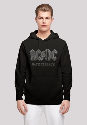 Black hooded sweatshirt featuring "AC/DC" logo and "BACK IN BLACK" text in silver, front pocket, and drawstrings. Smooth fabric texture.