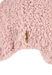 Fuzzy pink hat made of textured fabric, featuring a label on the side. The design includes ear-like accents for added detail.