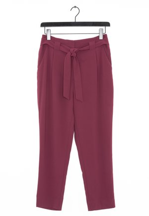Burgundy tapered pants with a belted waist, side pockets, and a smooth texture, hanging on a black hanger against a white background.