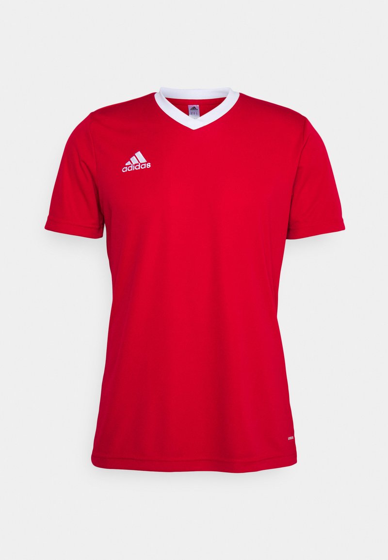 Piros Adidas focimez fehér V-nyakkal. Rövid ujjú és diszkrét logó a bal mellkasnál. Sima szövettextúra.