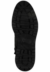 Semelle de chaussure en caoutchouc noir présentant des motifs de profondeur, des zones texturées et une zone centrale lisse pour une traction et une durabilité.