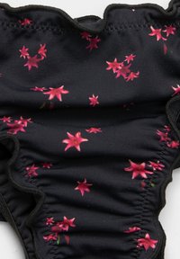 Fekete virágmintás bikini alsó fodros szélekkel, apró rózsaszín virágok mintázatával és sima, rugalmas textúrával.