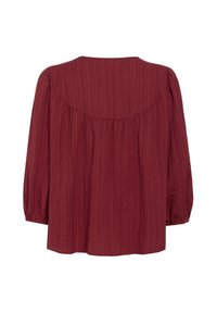 Maroon blouse with a loose fit, featuring long sleeves, a rounded neckline, and a textured ribbed design. Back has a cinched detailing.