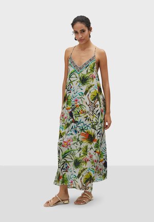 Vestido maxi de tejido ligero con un colorido patrón floral tropical. Escote en V con un ribete decorativo en blanco y negro.