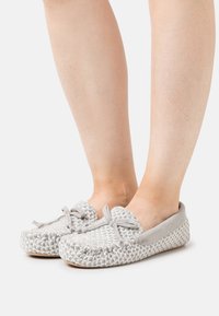 Gray woven slip-on shoes with suede accents and a rounded toe. Features a bow at the front and textured surface on the upper.