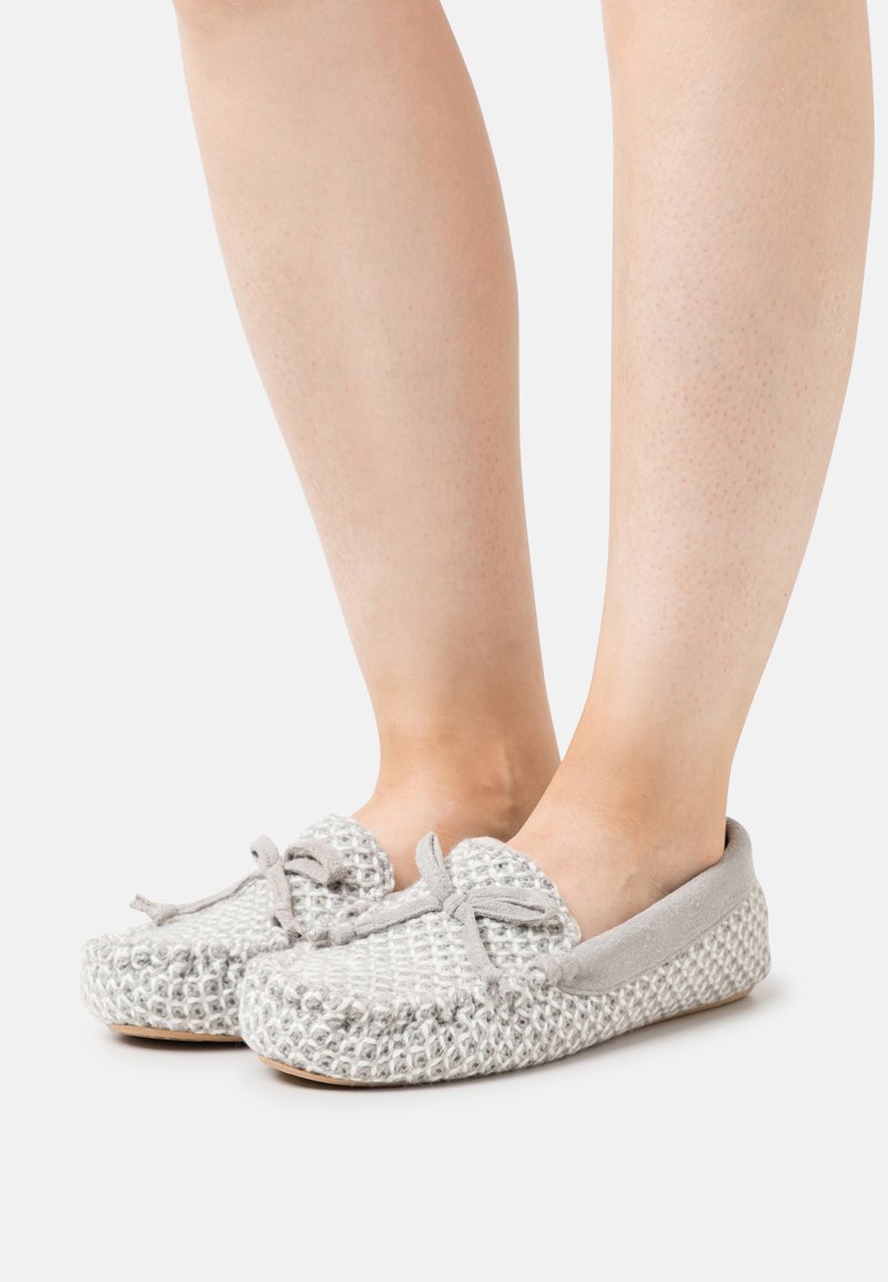 Gray woven slip-on shoes with suede accents and a rounded toe. Features a bow at the front and textured surface on the upper.