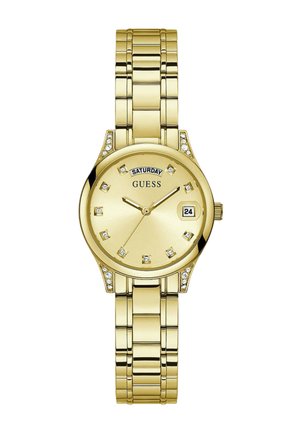 Montre-bracelet Guess ton or avec index des heures en cristal, affichage du jour et de la date, et bracelet métallique à maillons.