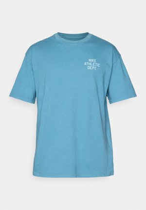 Blue cotton t-shirt with short sleeves, round neck, and "NIKE ATHLETIC DEPT." printed in white on the front. Relaxed fit.