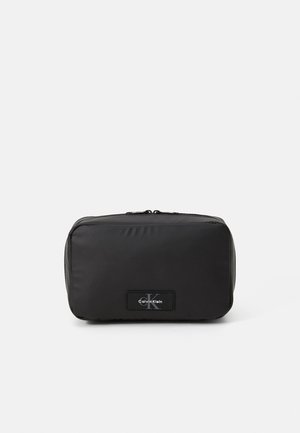 Black unisex pouch made of smooth nylon material. Rectangular shape, featuring a zip closure and a logo label on the front.