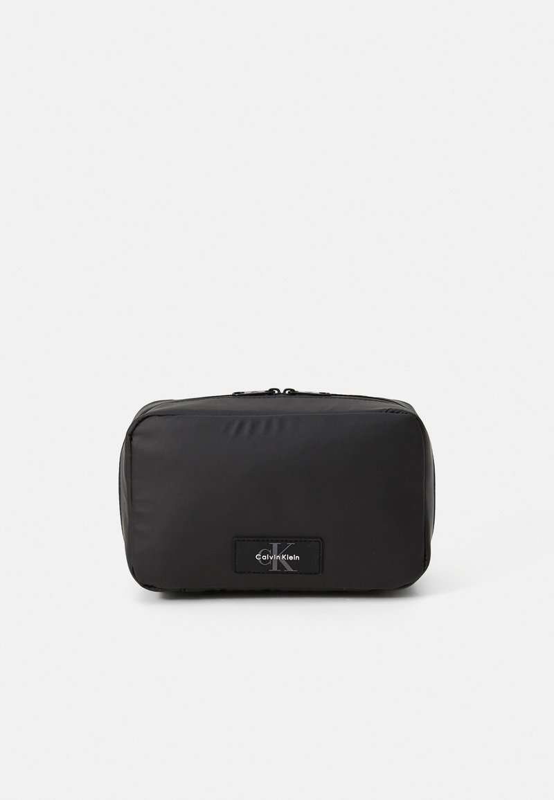 Black unisex pouch made of smooth nylon material. Rectangular shape, featuring a zip closure and a logo label on the front.