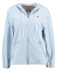 Light blue denim jacket with a hood, front zipper, drawstring at the waist, and two side pockets. Features elastic cuffs. Levi's branding.