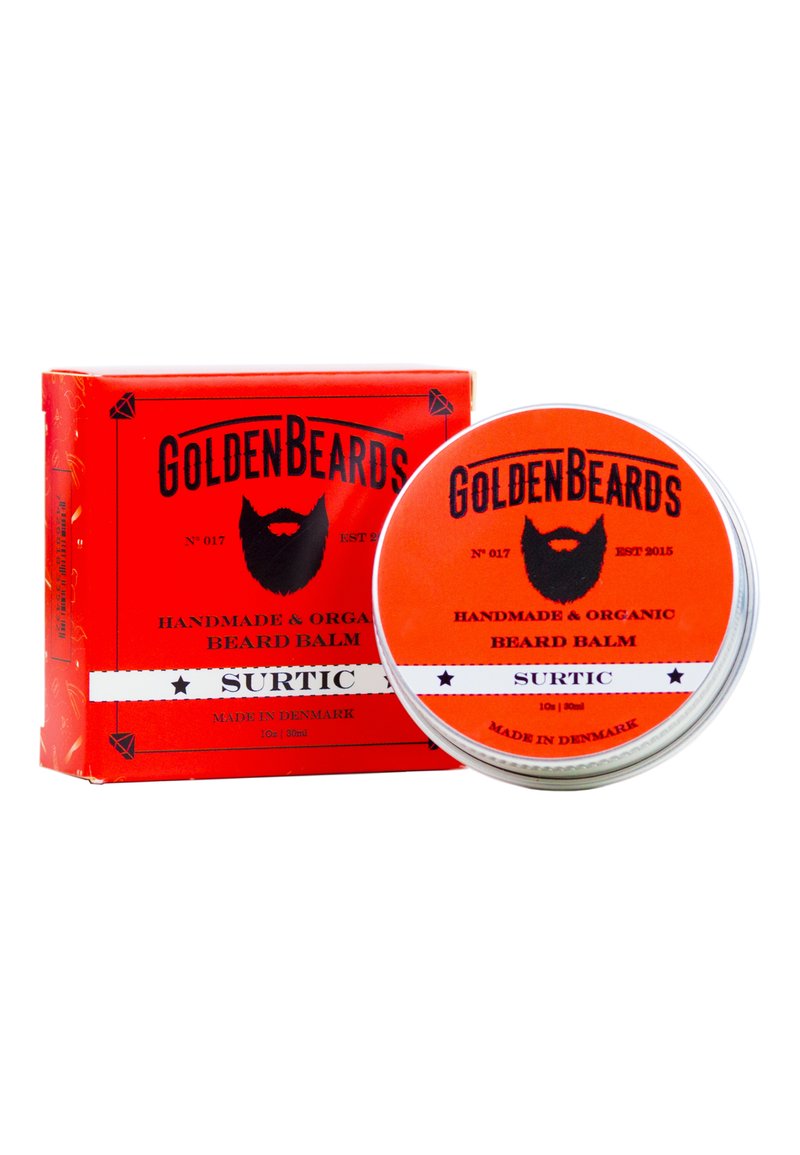 Röd låda med svart text och en grafik av ett skägg, innehållande ett silverfärgat lock med orange etikett. Produkten är ekologisk handgjord skäggbalsam, 30ml.
