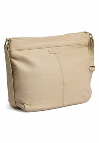Beige läderaxelväska med mjuk textur, rektangulär form och ett dragkedjestängd topp. Har en enkel logotypakcent på framsidan.