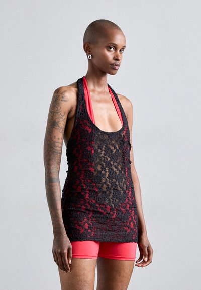 Black lace tank top with red accents, featuring a sheer design and halter neck. Paired with red shorts, smooth texture and fitted look.