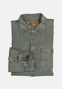 Folded long-sleeve slim fit shirt in faded green with buttons and two front pockets on a plain background.