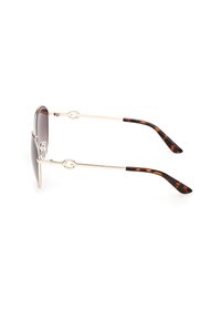 Ochelari de soare cu ramă subțire din metal auriu, lentile cu gradient închis și vârfuri curbate ale branțurilor cu model tartar, văzuți din profil.