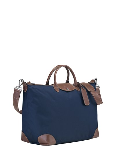 Marineblaues Nylon-Etui mit braunen Lederakzenten, strukturierte Form, doppelte Griffe, abnehmbarer Schultergurt und einem kleinen Lederetikett.