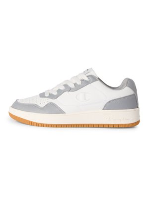 Biało-szary niski sneaker z gumową podeszwą, zapinany na sznurowadła, z wytłoczonym logo Champion po boku i na podeszwie.