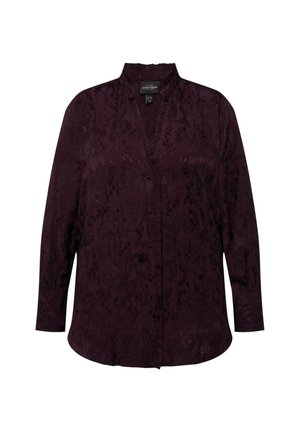 Tumme lila blus med mandarinkrage, knäppning fram, långa ärmar och blommönster genom hela plagen.