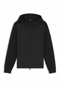 Svart zip-up hoodie tillverkad av mjukt material, med huva, två bröstfickor med dragkedja och ribbade muddars, med en stilren, minimalistisk design.