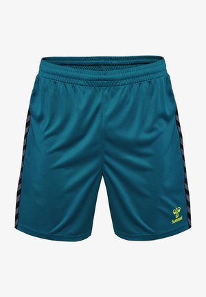 Tealowe spodenki sportowe wykonane z gładkiego materiału, z czarnymi paskami po bokach i żółtym logo na dolnej prawej stronie. Zawierają elastyczny pas.