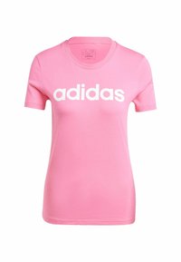 Pink cotton t-shirt featuring a crew neck and short sleeves, prominently displaying "adidas" in large white letters across the front.