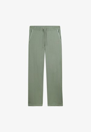Pantaloni della tuta verde chiaro a gamba dritta con vita elastica con coulisse e tasche laterali, distesi su sfondo bianco.
