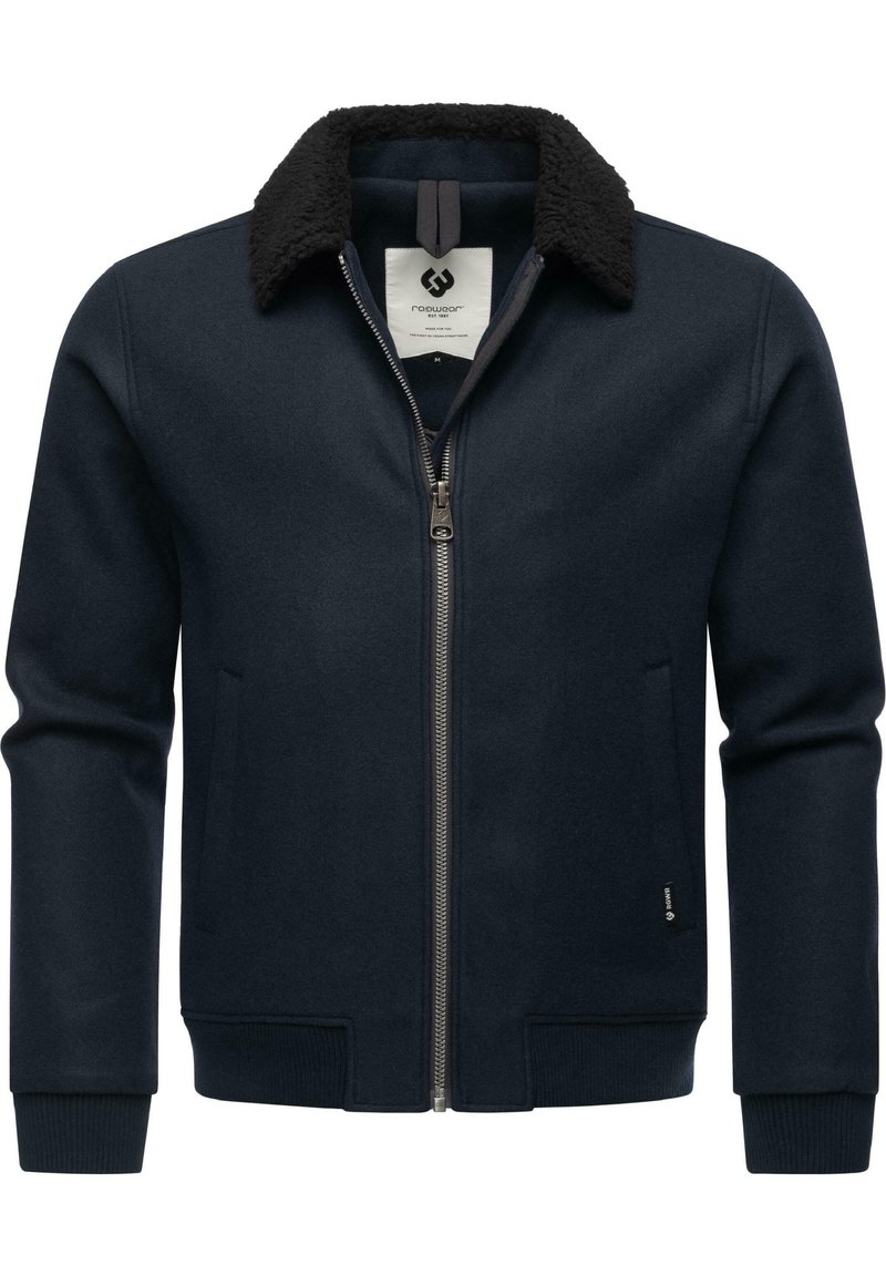 Dark navy jacket with a zip front, featuring a black faux fur collar, ribbed cuffs, and side pockets, made from a wool-like material.