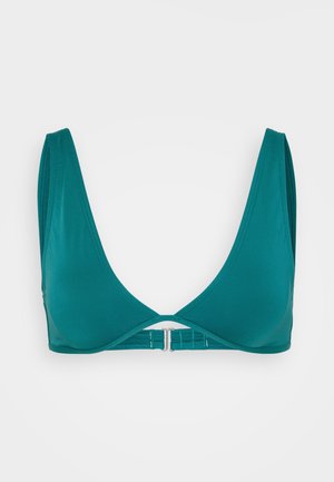 Teal triangle bralette made of smooth fabric, featuring wide straps, a low neckline, and a metal clasp closure at the back.