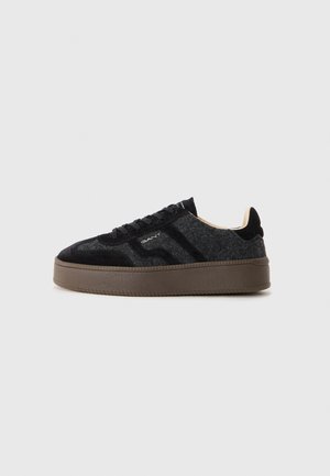Sneakers with a black and gray texture, featuring a suede upper, round toe, lace-up design, and a thick brown rubber sole.