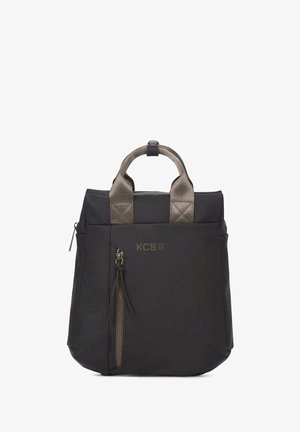 Sac fourre-tout en nylon noir avec poignées courtes rembourrées, poche extérieure zippée et logo KCB en bronze. Forme carrée avec une texture lisse.