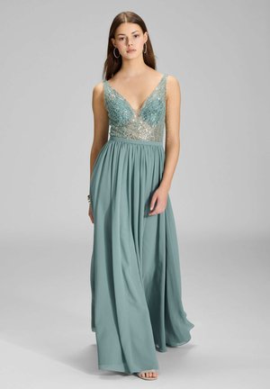 Długa turkusowa suknia z głębokim dekoltem w szpic i cekinowym koronką. Zwiewna spódnica z szyfonu, dopasowana talia i szerokie ramiączka. Gładka tekstura.