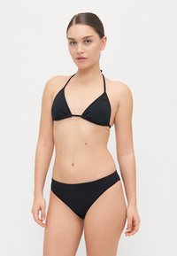 Black bikini set featuring a triangular top with adjustable straps and a simple bottom. Smooth fabric with minimal stitching details.