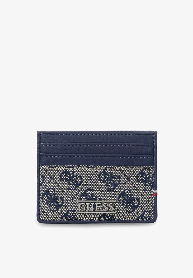 Navy and beige patterned Guess cardholder with multiple card slots, metal logo, and small tricolor fabric detail on the side.