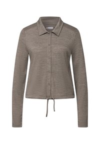 Chemise à manches longues avec col boutonné, de couleur gris clair, en tissu texturé, avec un cordon de serrage à l'ourlet pour un ajustement réglable.