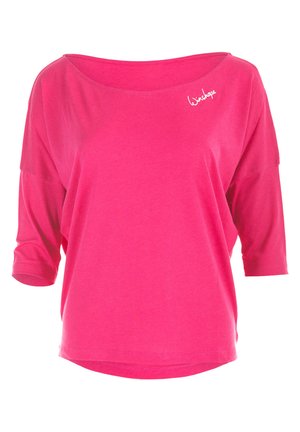 Fuchsia oversized t-shirt with 3/4 sleeves, a wide neckline, and a stitched brand detail on the shoulder. Soft, lightweight fabric.