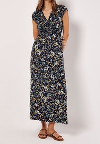 Floral maxi dress with short cap sleeves, gathered bodice, and navy background. Features multi-colored floral patterns and a flowing silhouette.