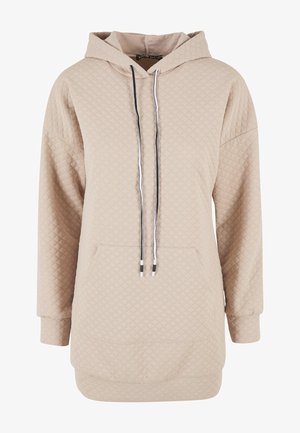 Béžová mikina s kapucňou a prešívaným vzorom, s prednou vreckom a čiernymi šnúrkami. Dlhé rukávy s rebrovanými manžetami.