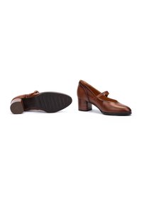 Escarpins Mary Jane en cuir marron avec un bout arrondi, une bride unique sur le cou-de-pied et une semelle en caoutchouc texturé, dotés d'un talon cylindrique.